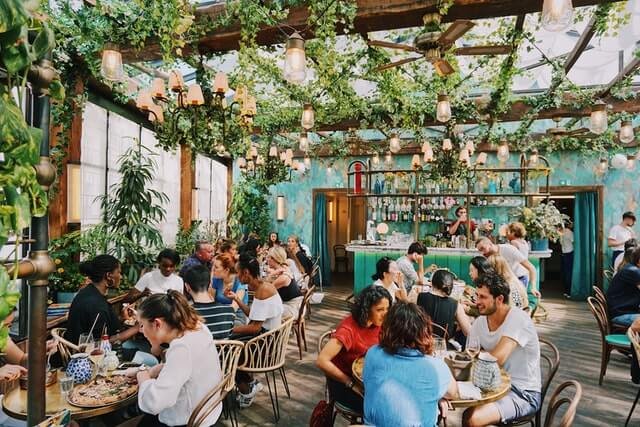 Home Guests enjoying delicious Italian food in a busy family-friendly restaurant
