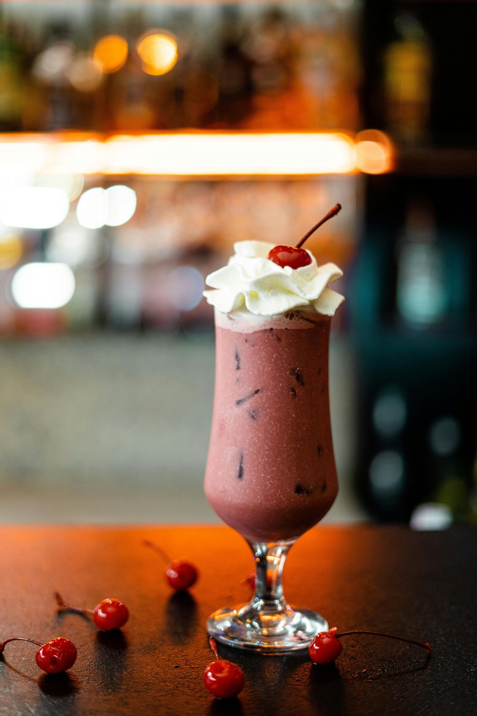 A rich chocolate milkshake topped with whipped cream and a cherry, perfect for dessert lovers.